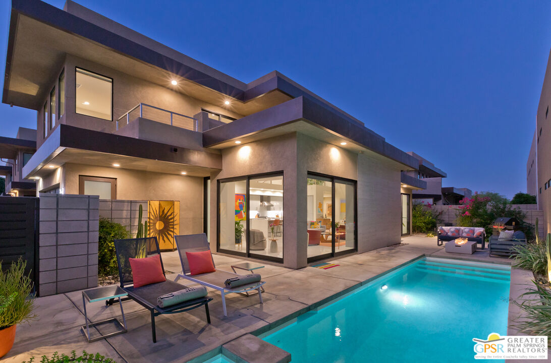 a patio with yard and outdoor seating