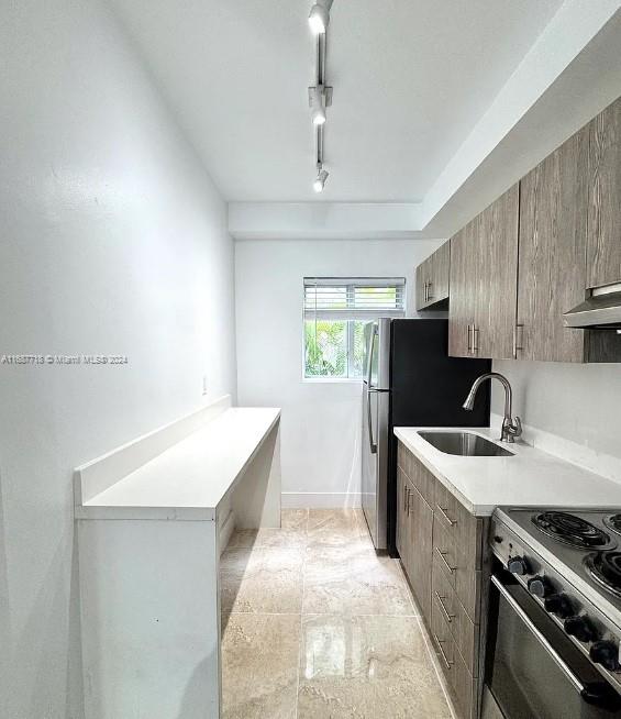 a kitchen with a sink stove and refrigerator