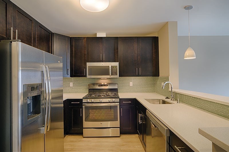 a kitchen with a sink appliances and cabinets