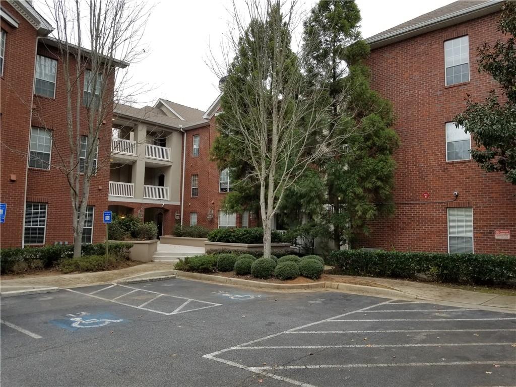 a view of a brick building next to a road