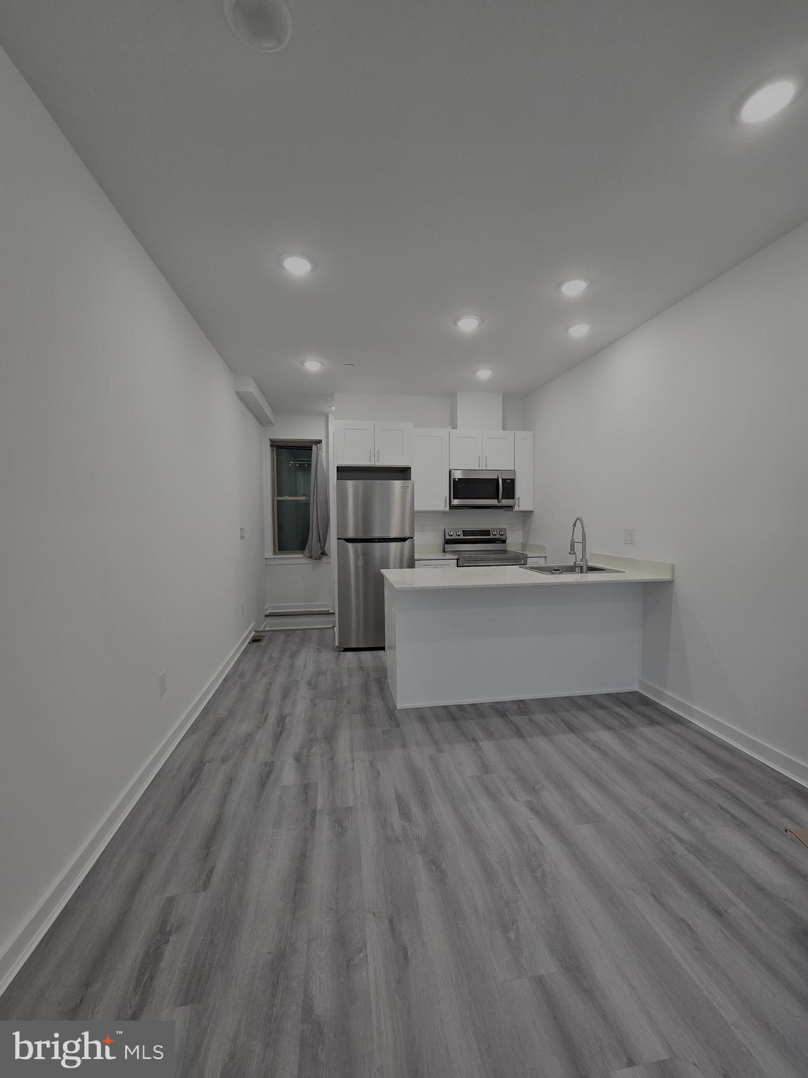 a view of kitchen with wooden floor