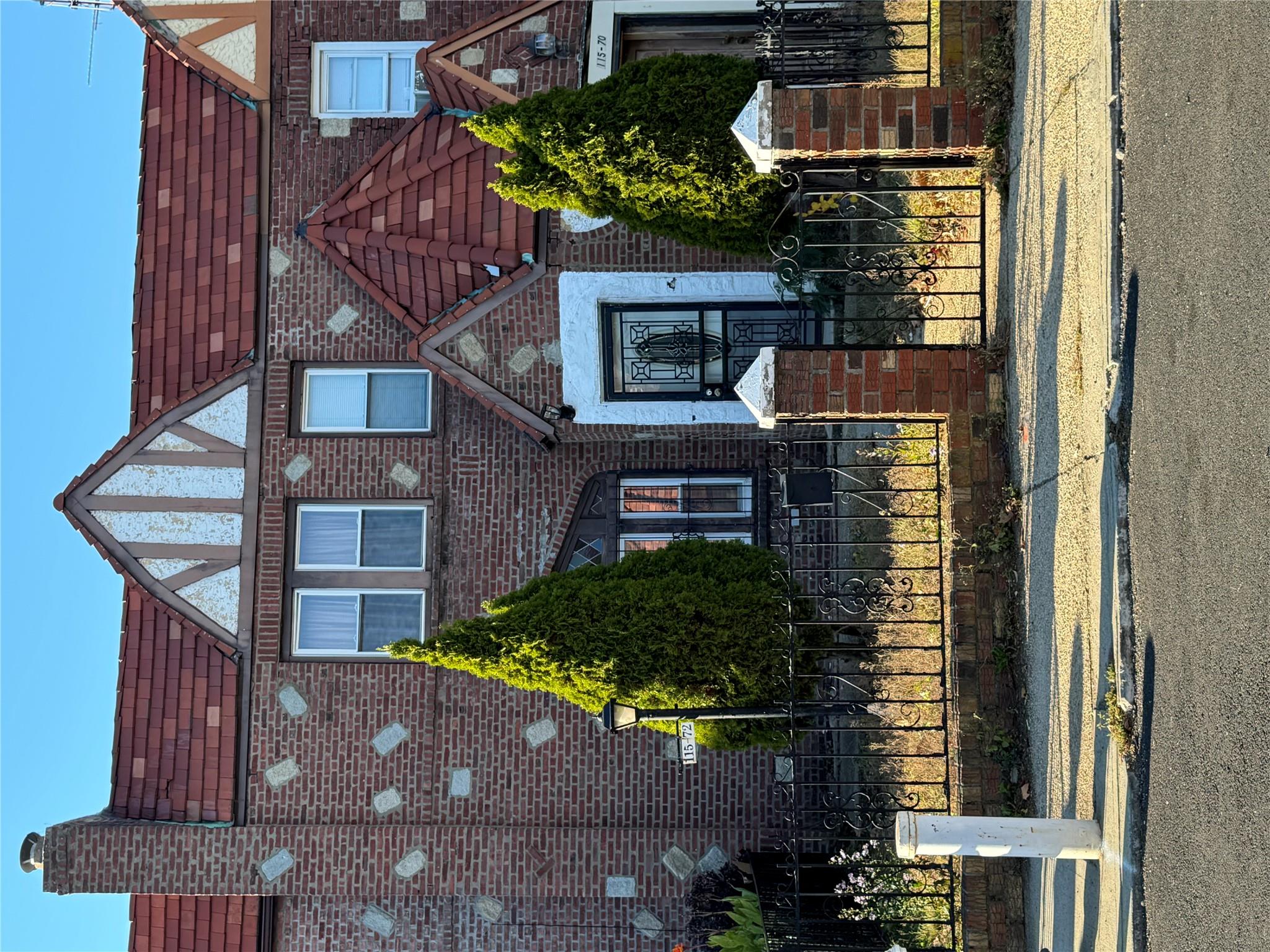 a front view of a house with a garden