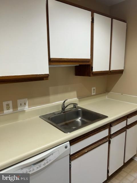 a kitchen with a sink cabinets and a wooden floor