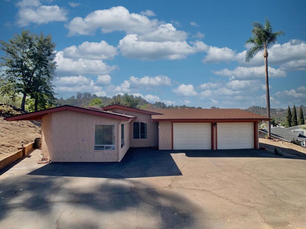 a view of a house with a backyard