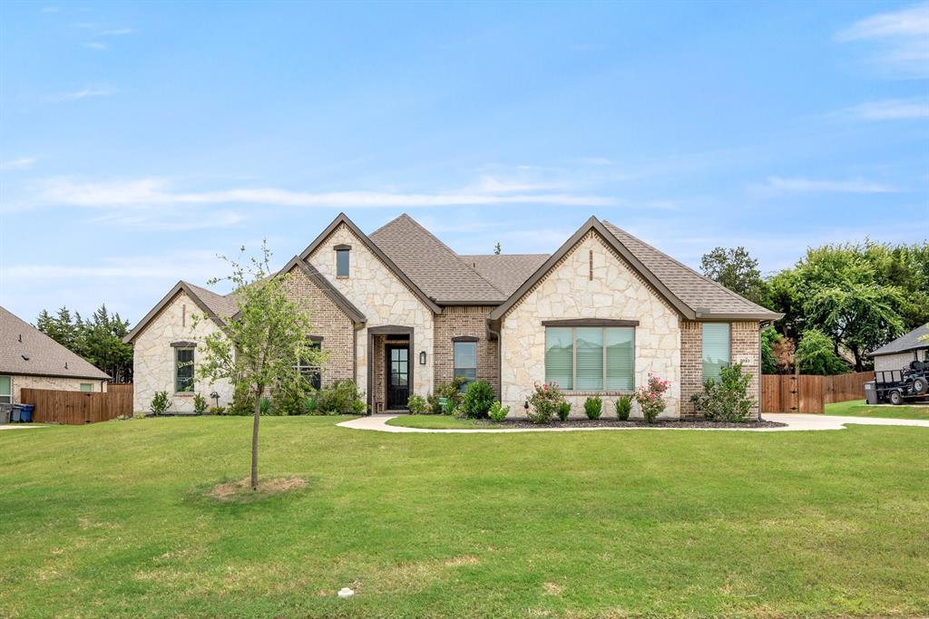 a front view of house with yard and green space