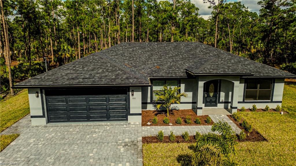 a front view of a house with basket ball court and outdoor seating