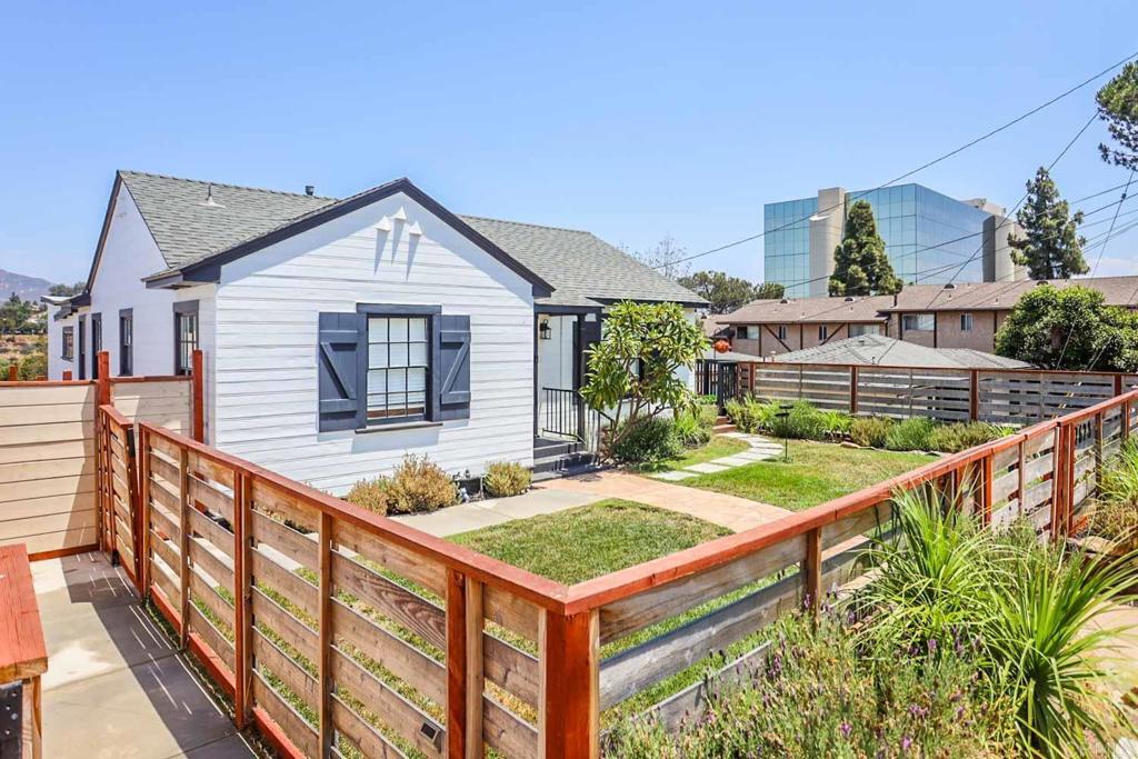 a view of a house with wooden deck and furniture