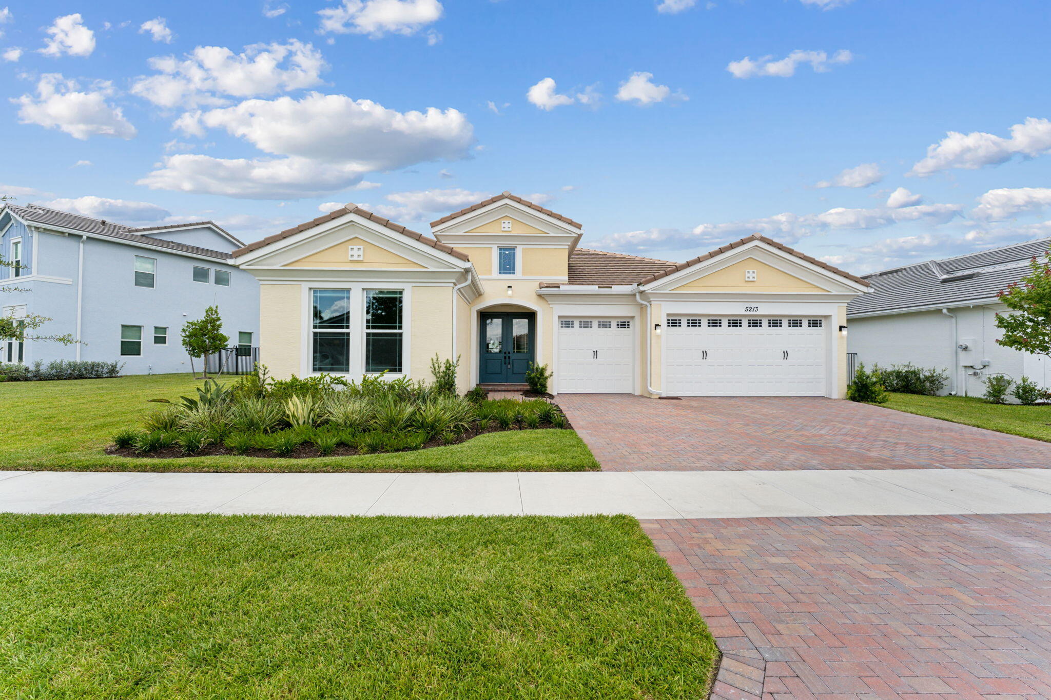 a front view of a house with a yard and garage