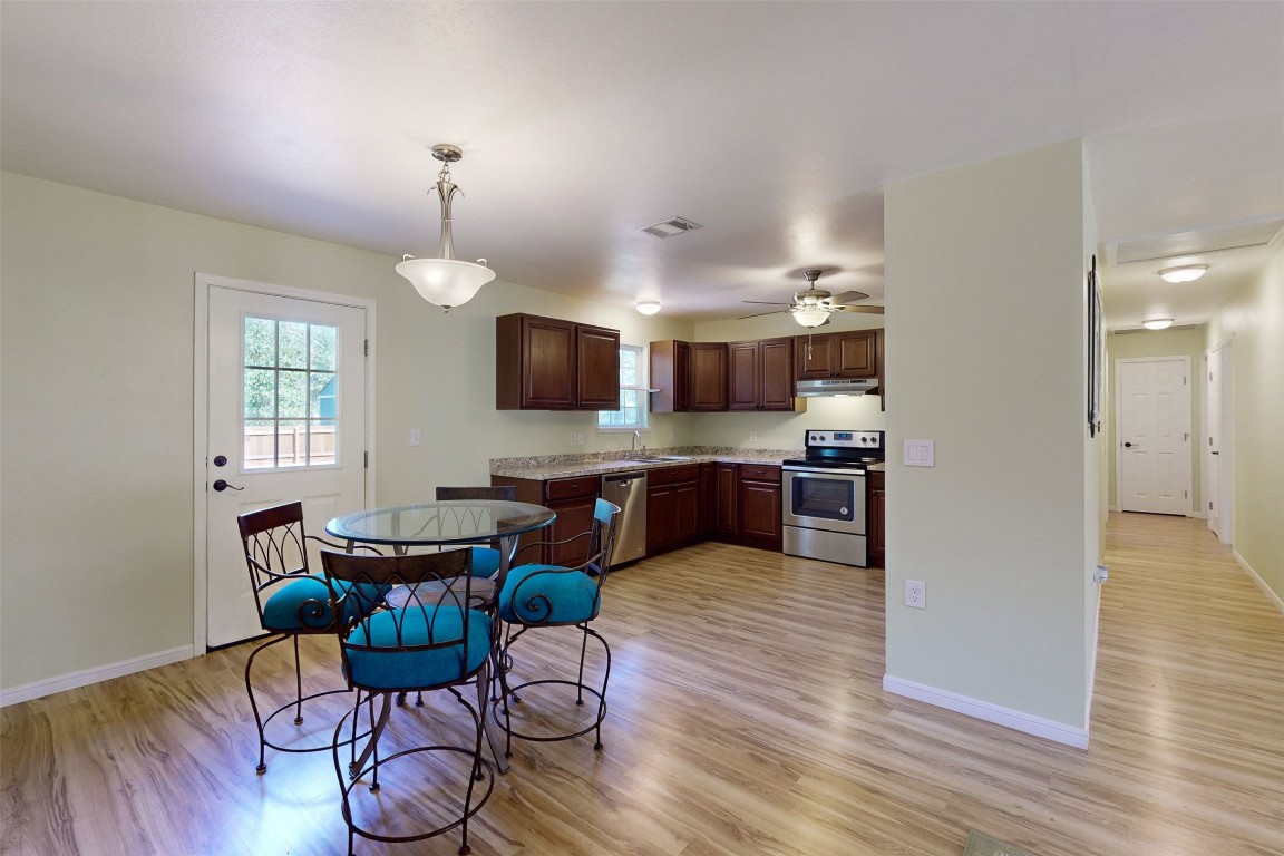 a view of kitchen with cabinets and wooden floor