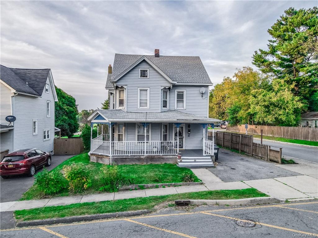 a front view of a house with a yard and potted plants