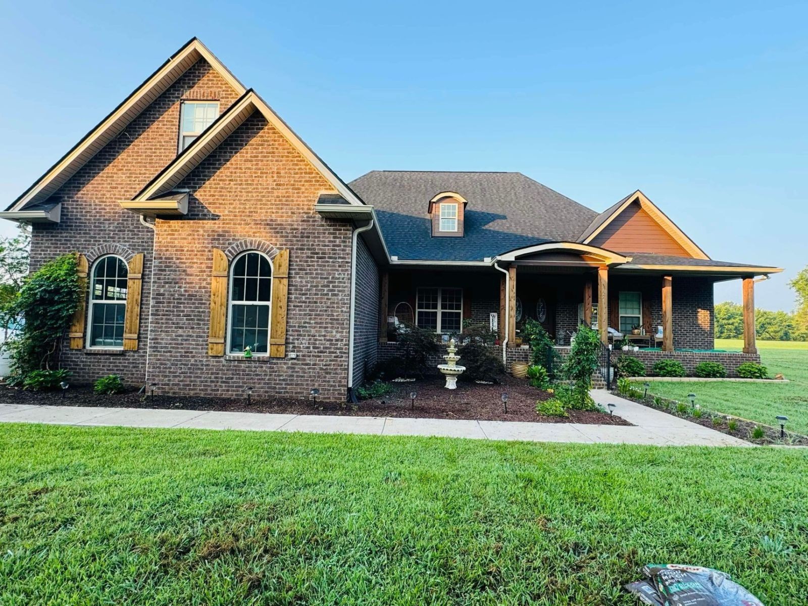 a front view of a house with a yard and porch