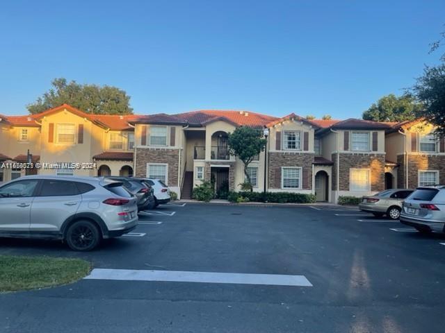 a front view of a house with parking space