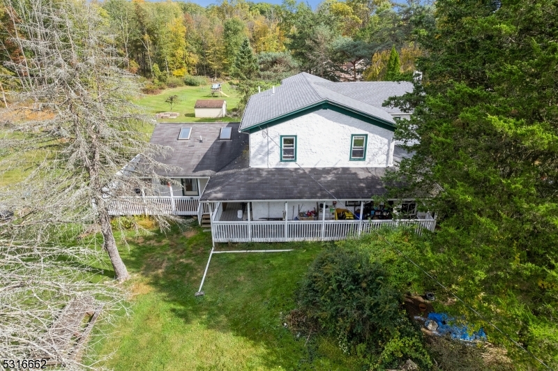 a aerial view of a house with a yard table and chairs