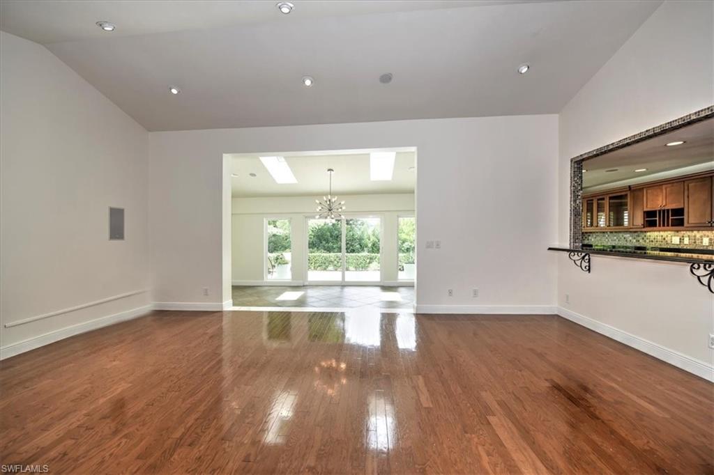 a view of empty room with wooden floor and fireplace