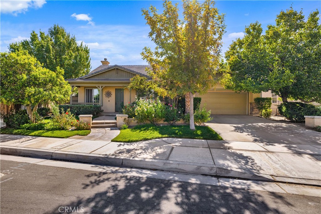 a view of a house with a yard and tree s