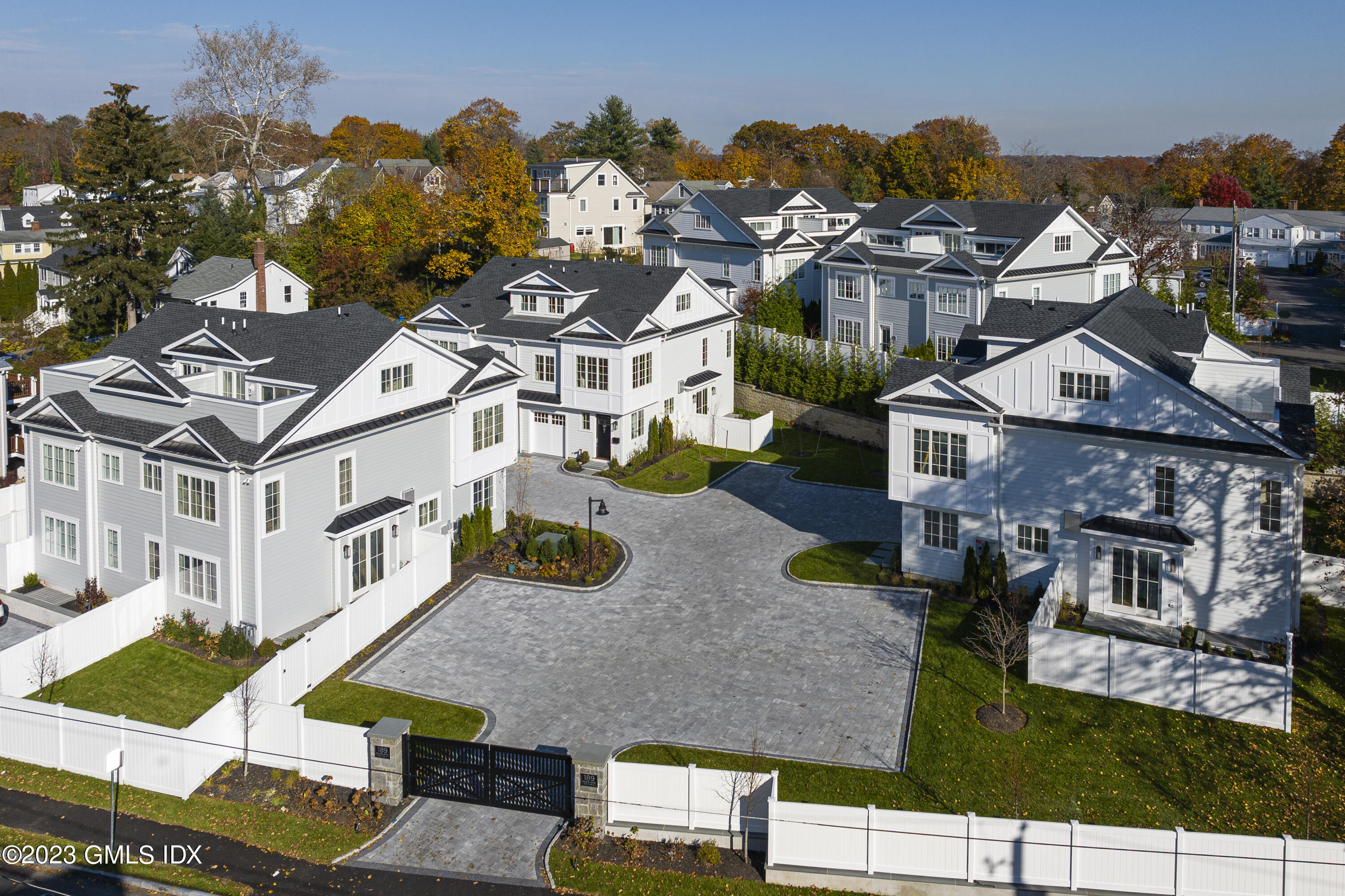 an aerial view of multiple houses with a yard