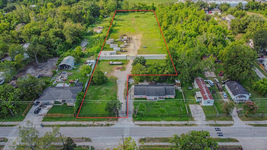 an aerial view of a house with a yard and outdoor seating