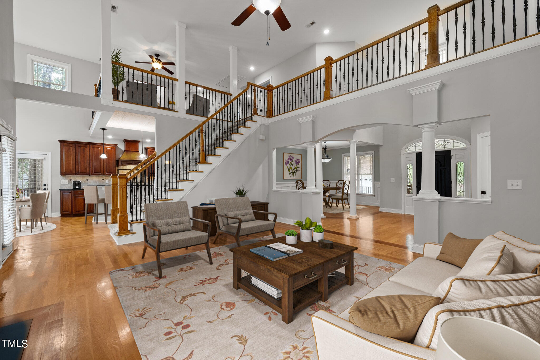 a living room with furniture ceiling fan and a rug