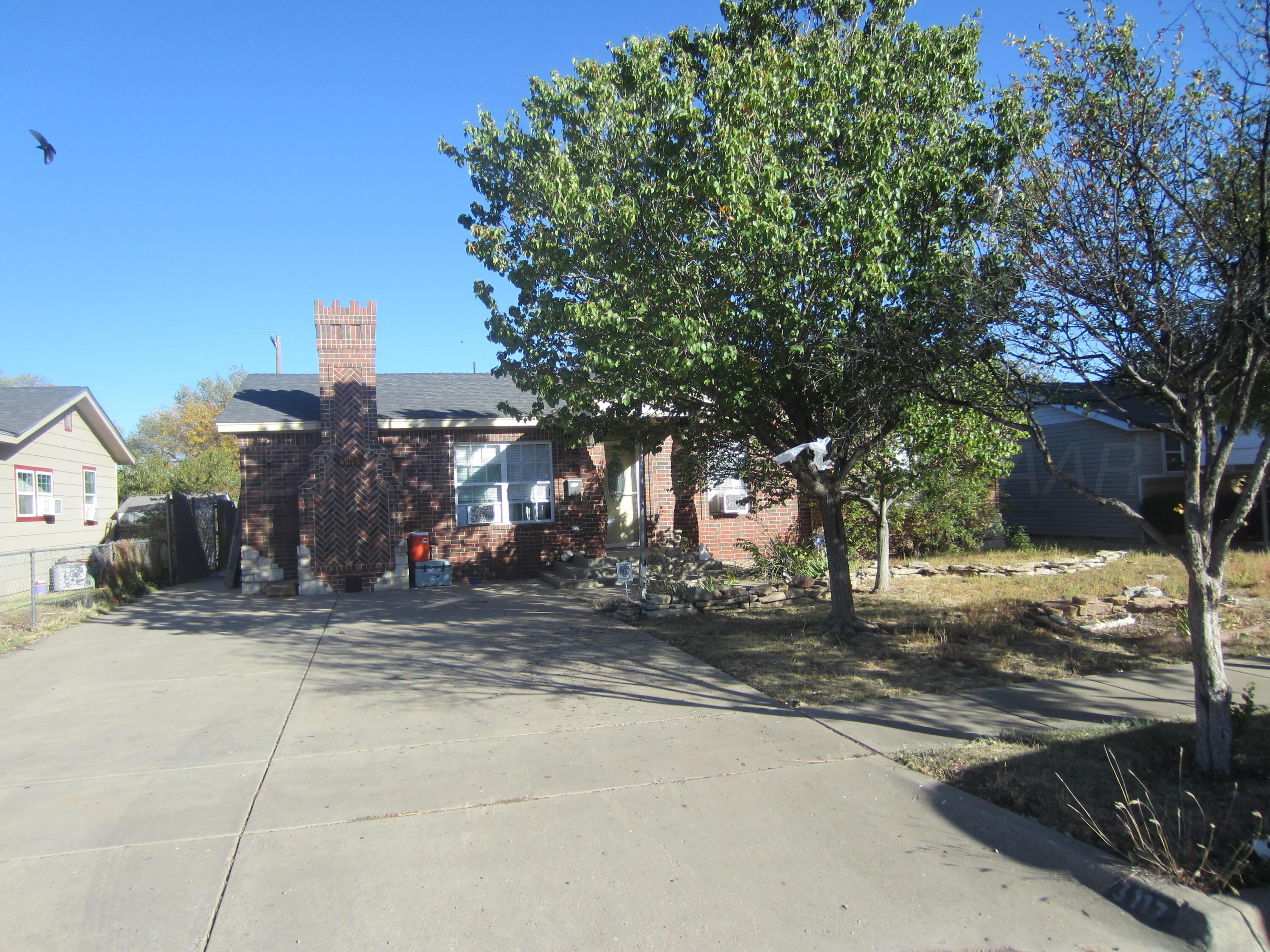 a street view with large trees