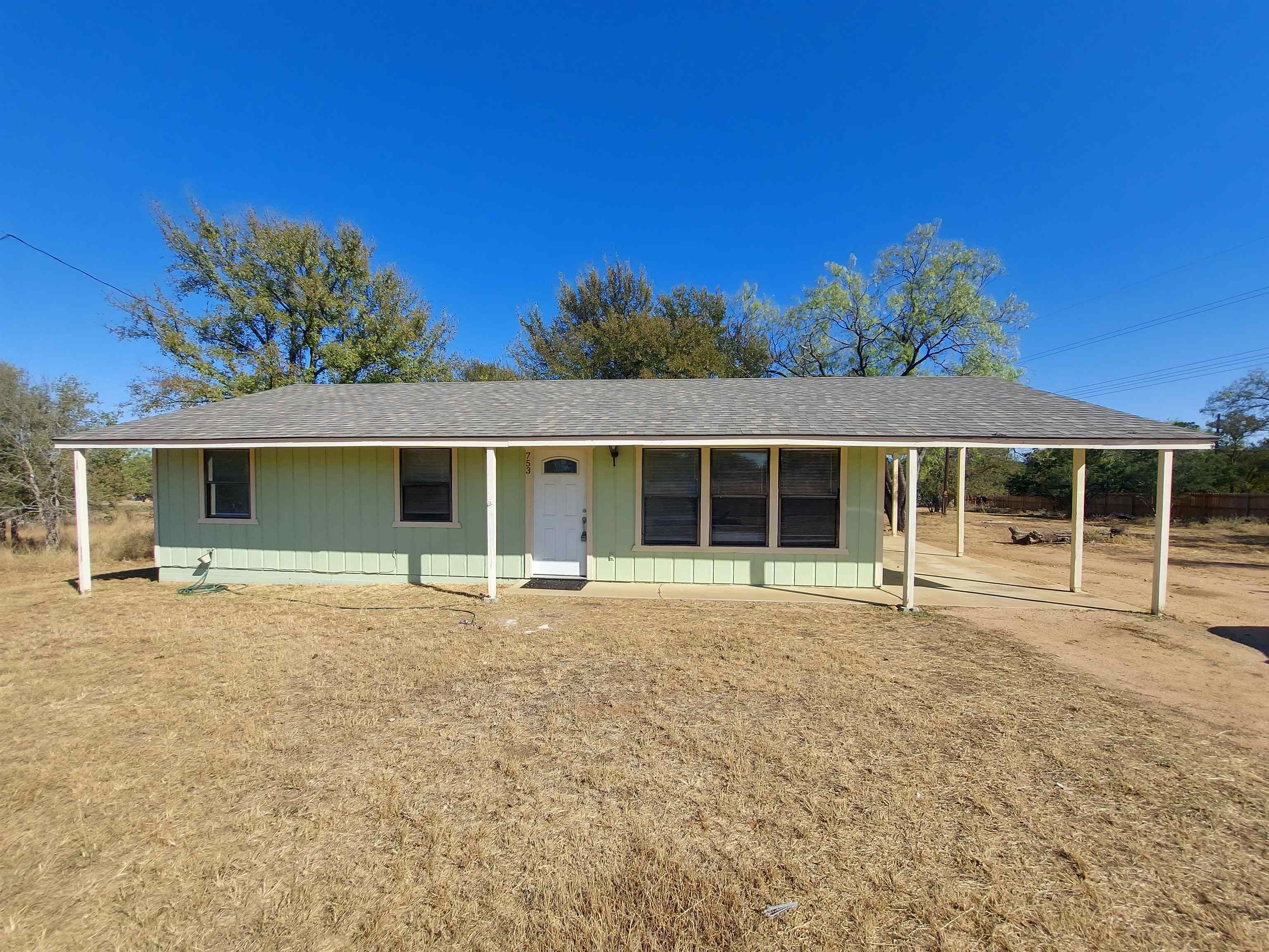 front view of a house with a large window and a yard