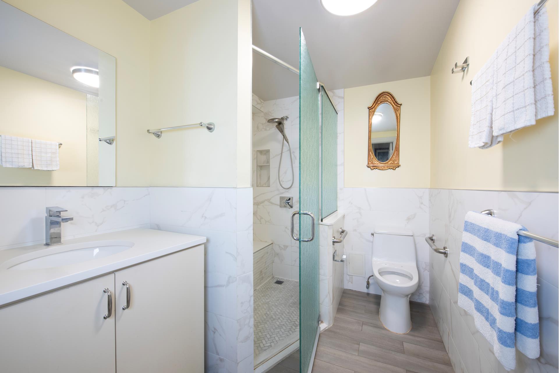 a bathroom with a sink and mirror with toilet