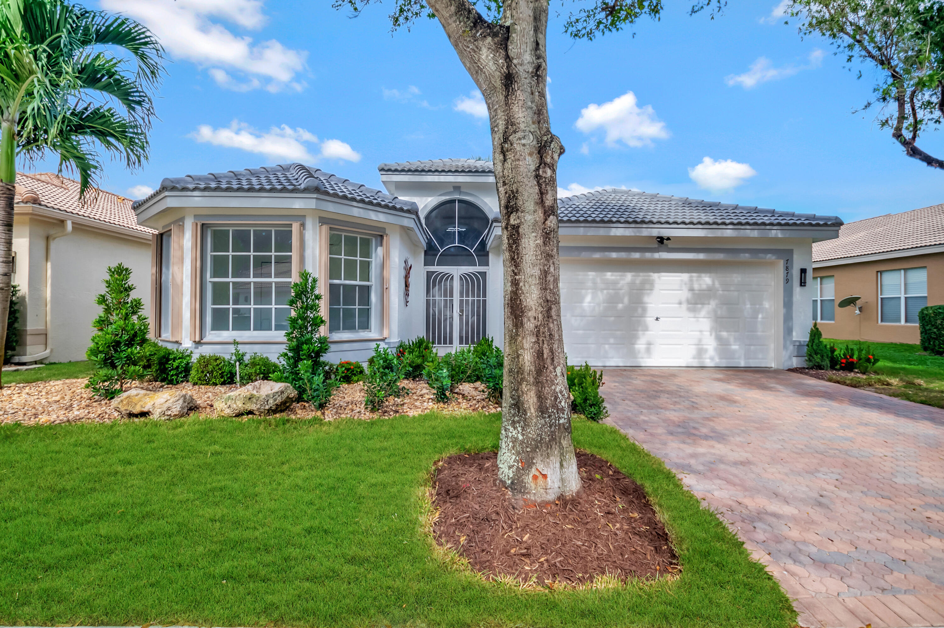 a front view of a house with a yard and garage