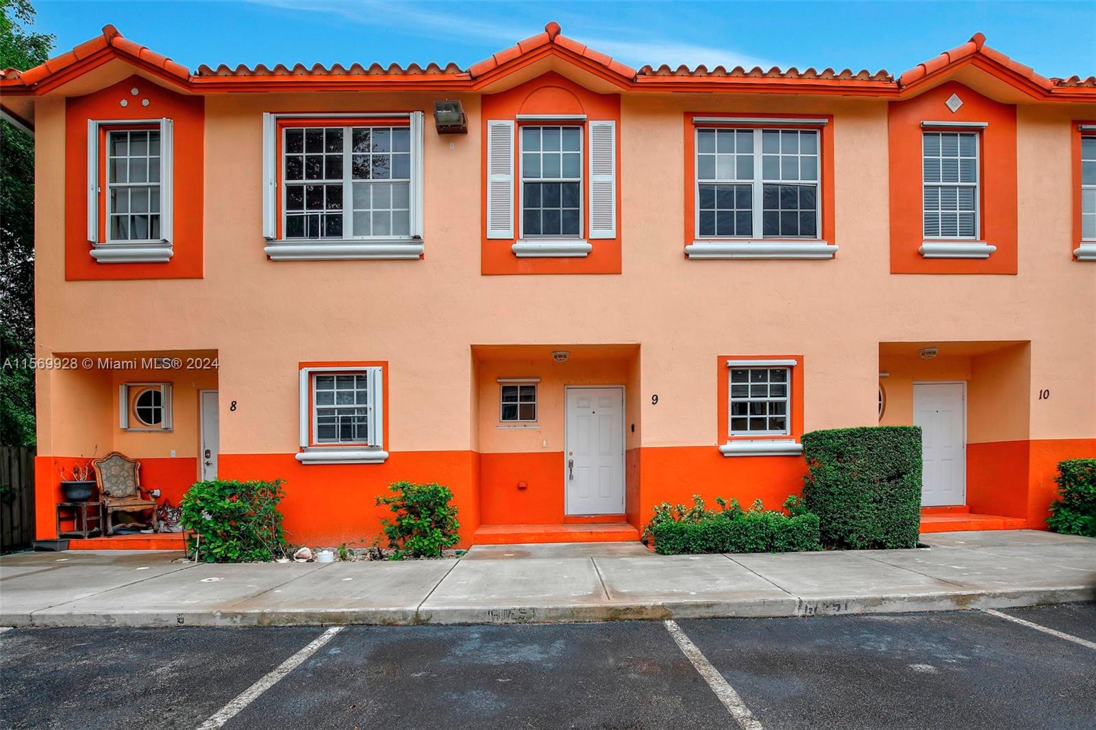 front view of a brick house with a yard