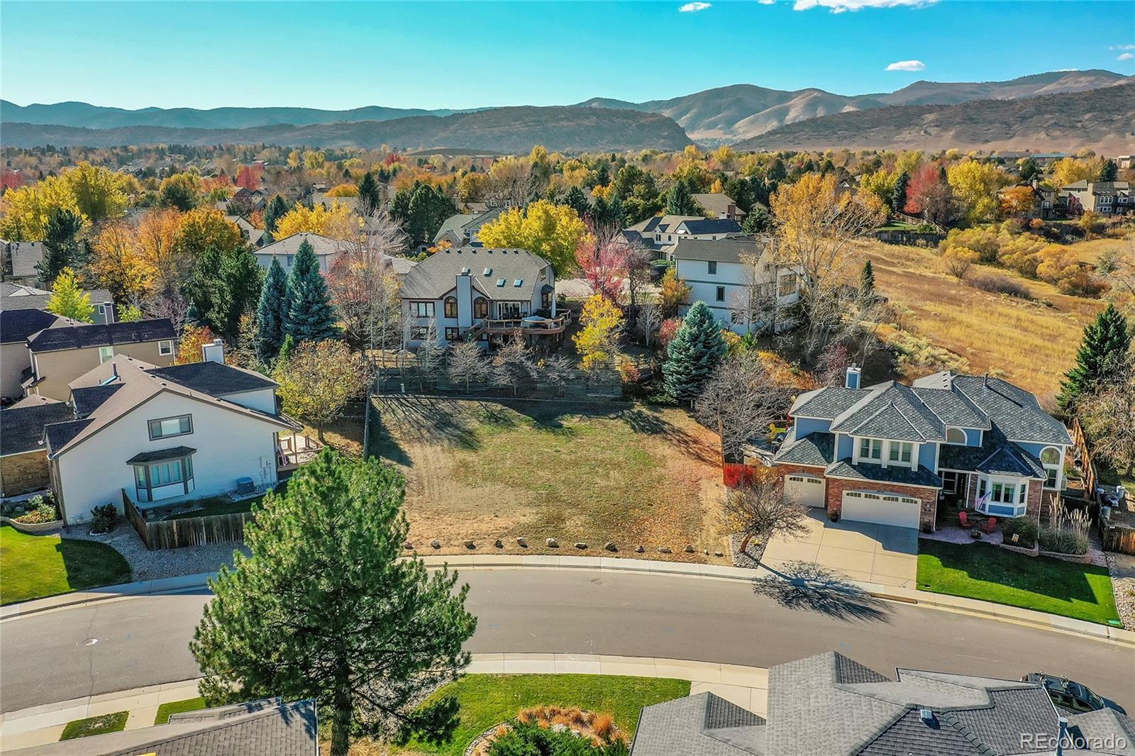 an aerial view of residential houses with outdoor space and river