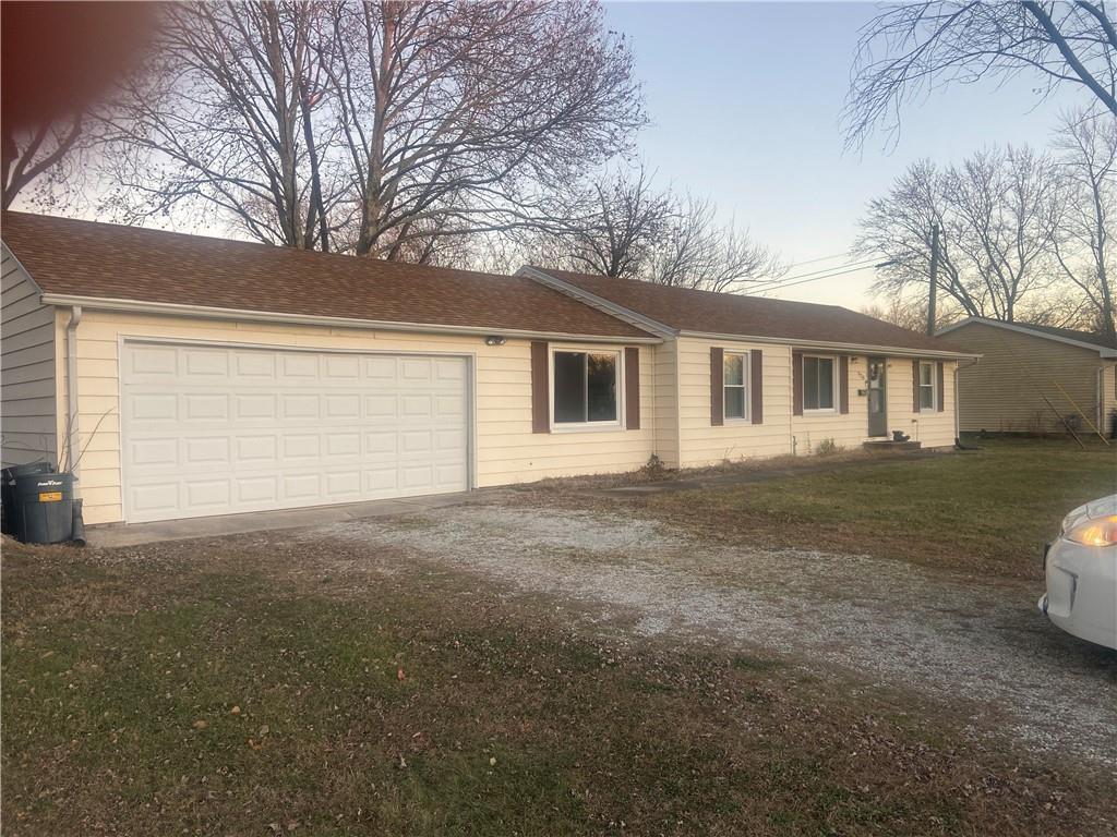 a view of a house with a yard and garage