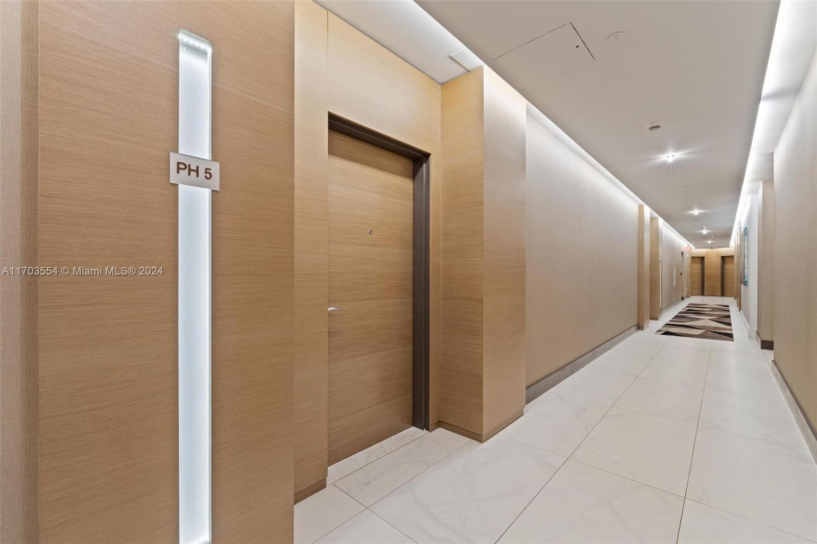 a view of a hallway with stairs