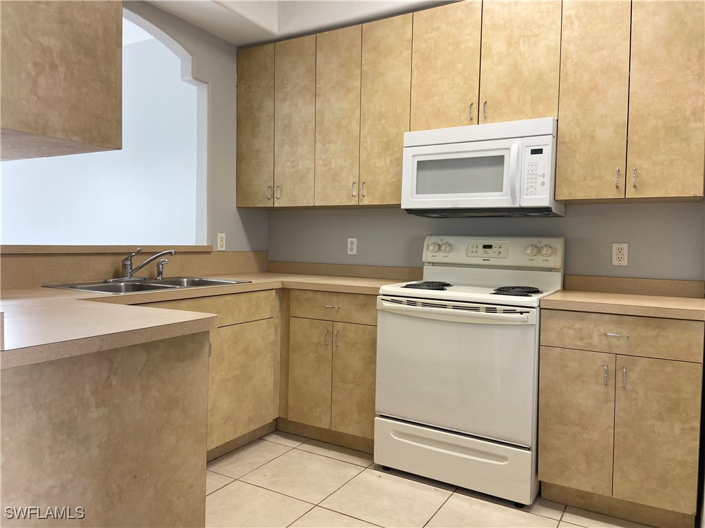 a kitchen with stainless steel appliances white cabinets and a sink