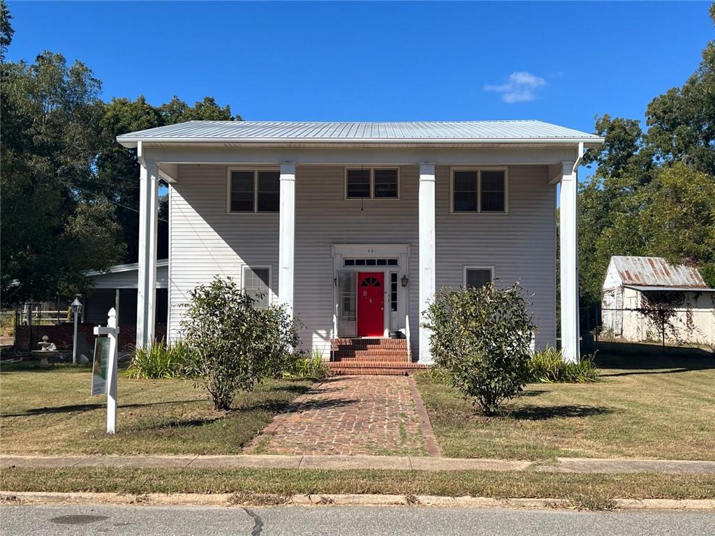 a front view of a house with garden