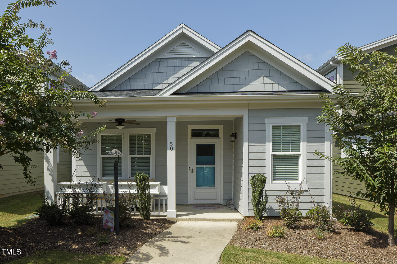 a front view of a house with outdoor seating