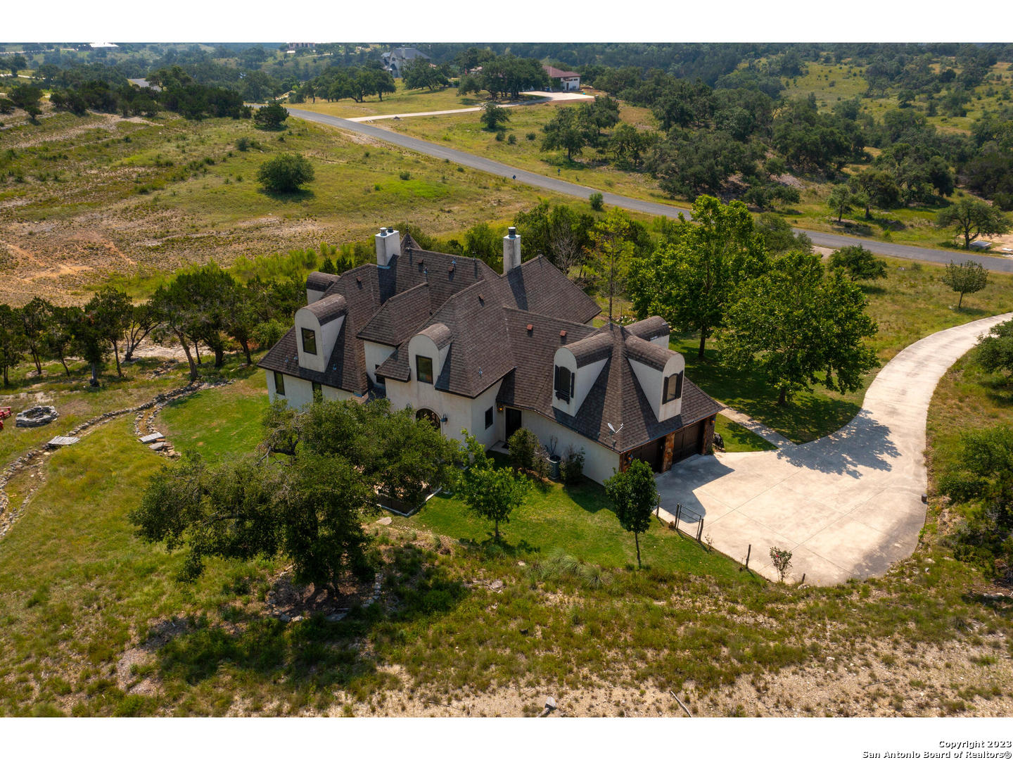 an aerial view of residential houses with outdoor space and river