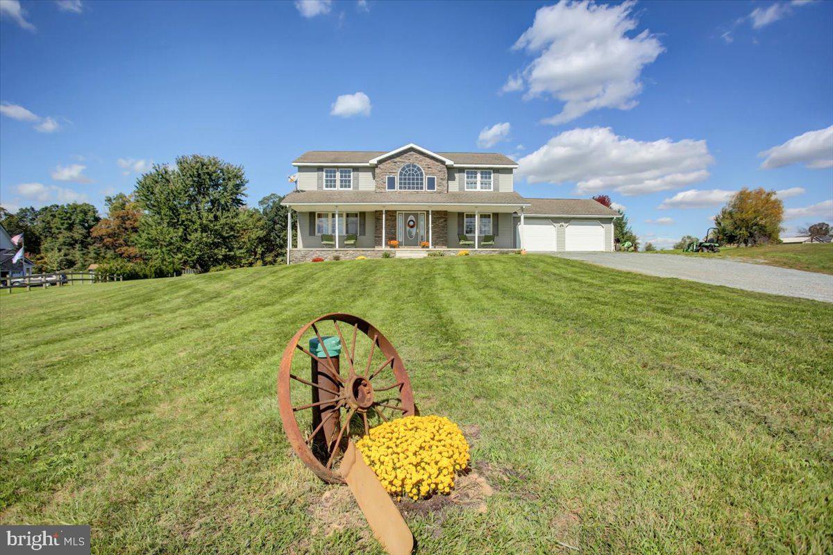 a view of a big house with a big yard and potted plants