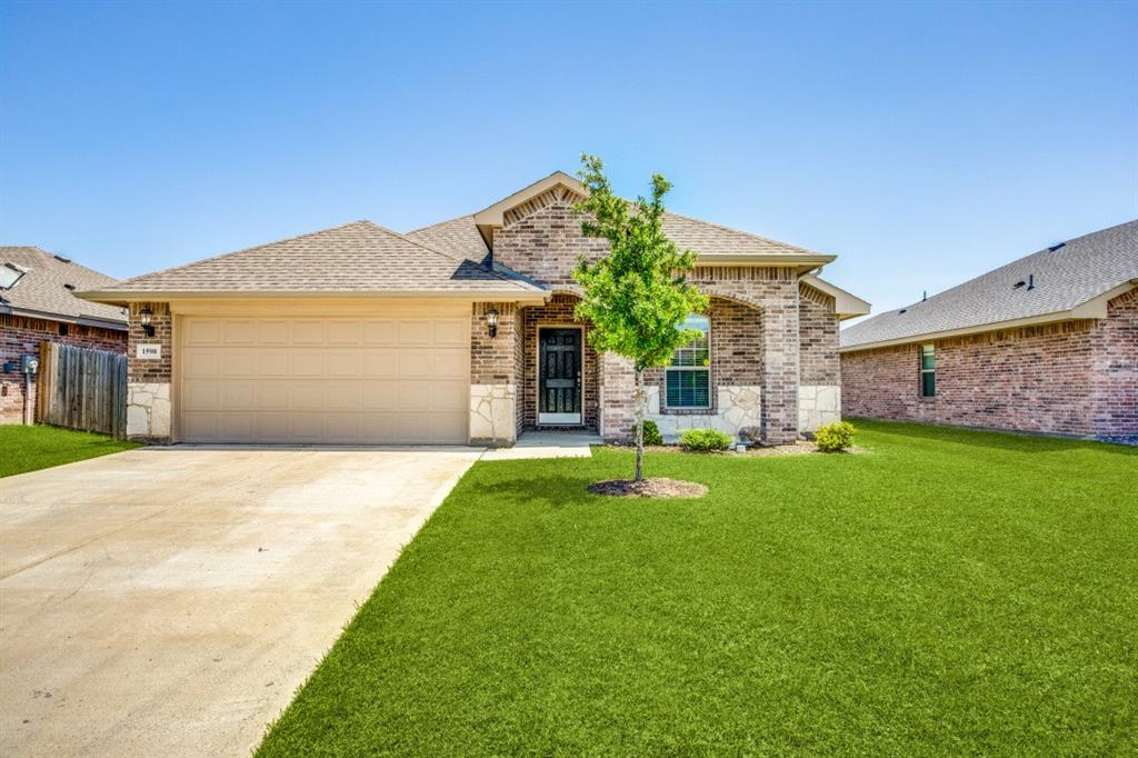 a front view of a house with a garden and yard