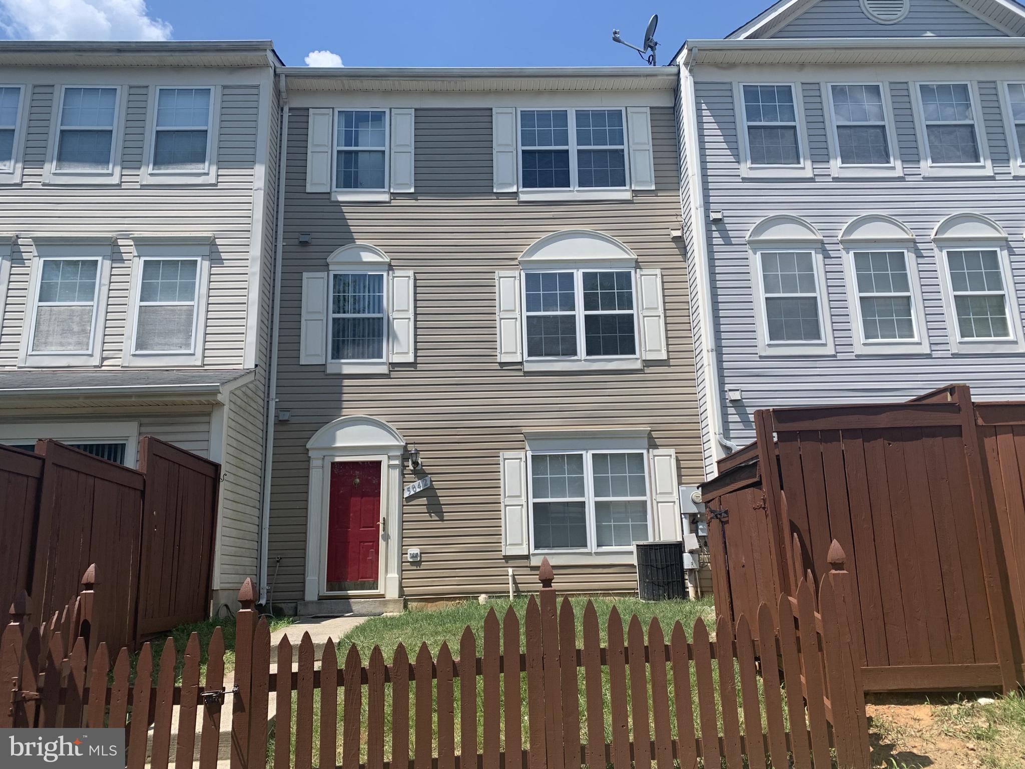 a front view of a residential apartment building with a yard