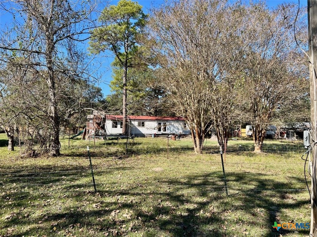 a view of a yard with a tree