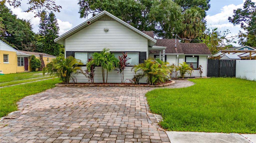 a front view of a house with a yard and porch