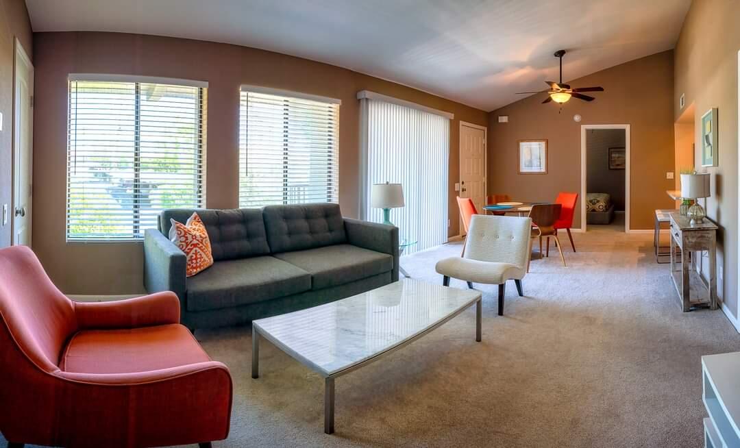 a living room filled with furniture and a large window