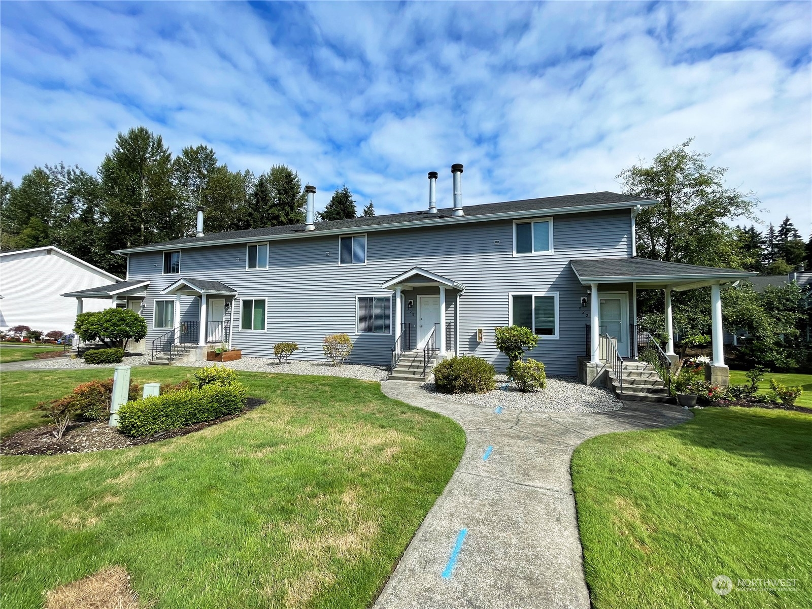 a front view of house with yard and outdoor seating