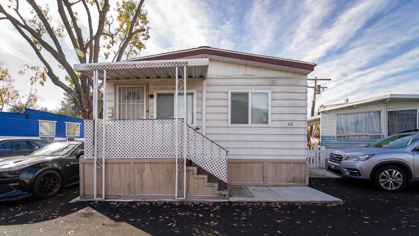 a view of a car park side of a house