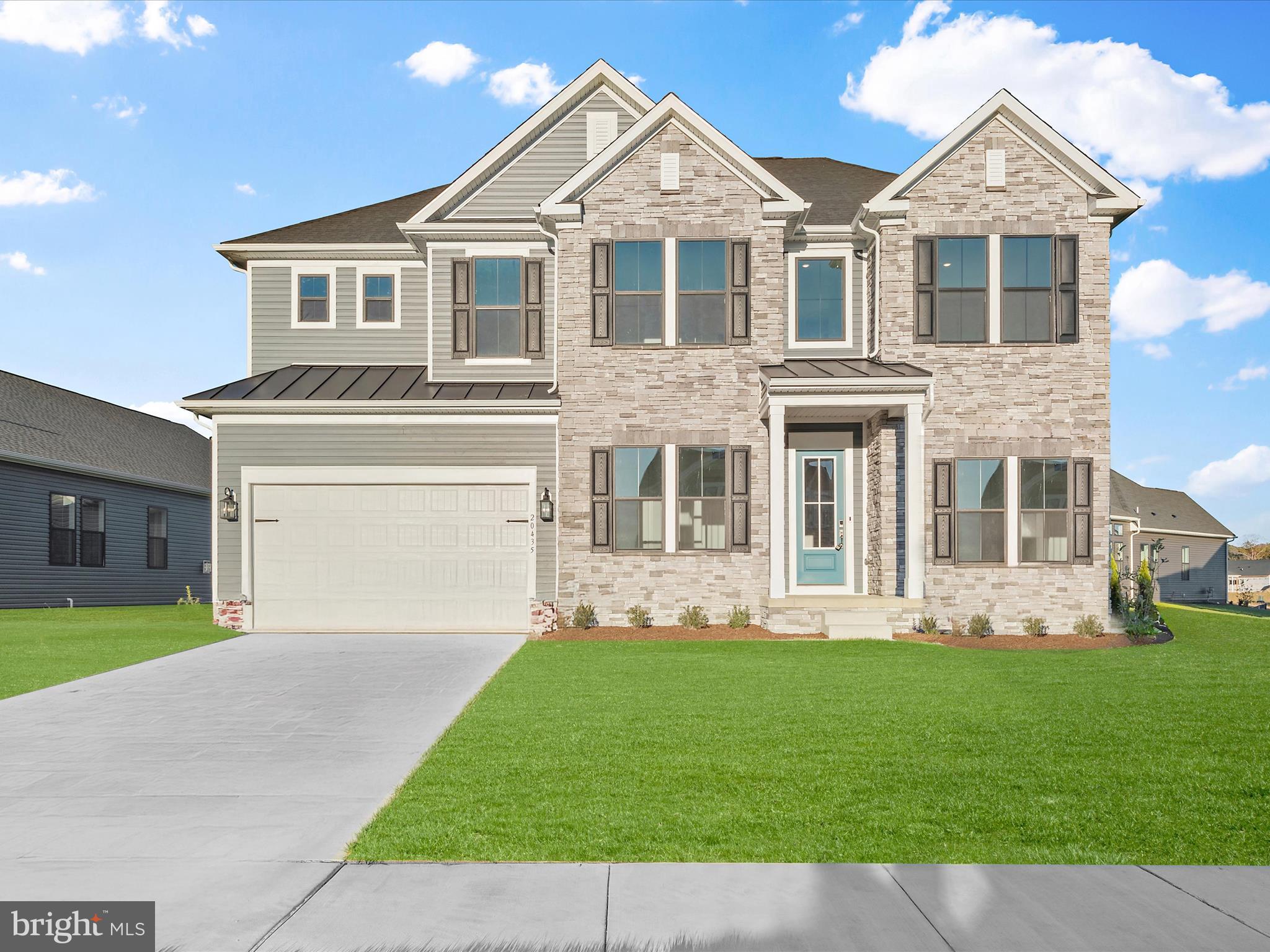 a front view of a house with a yard and porch