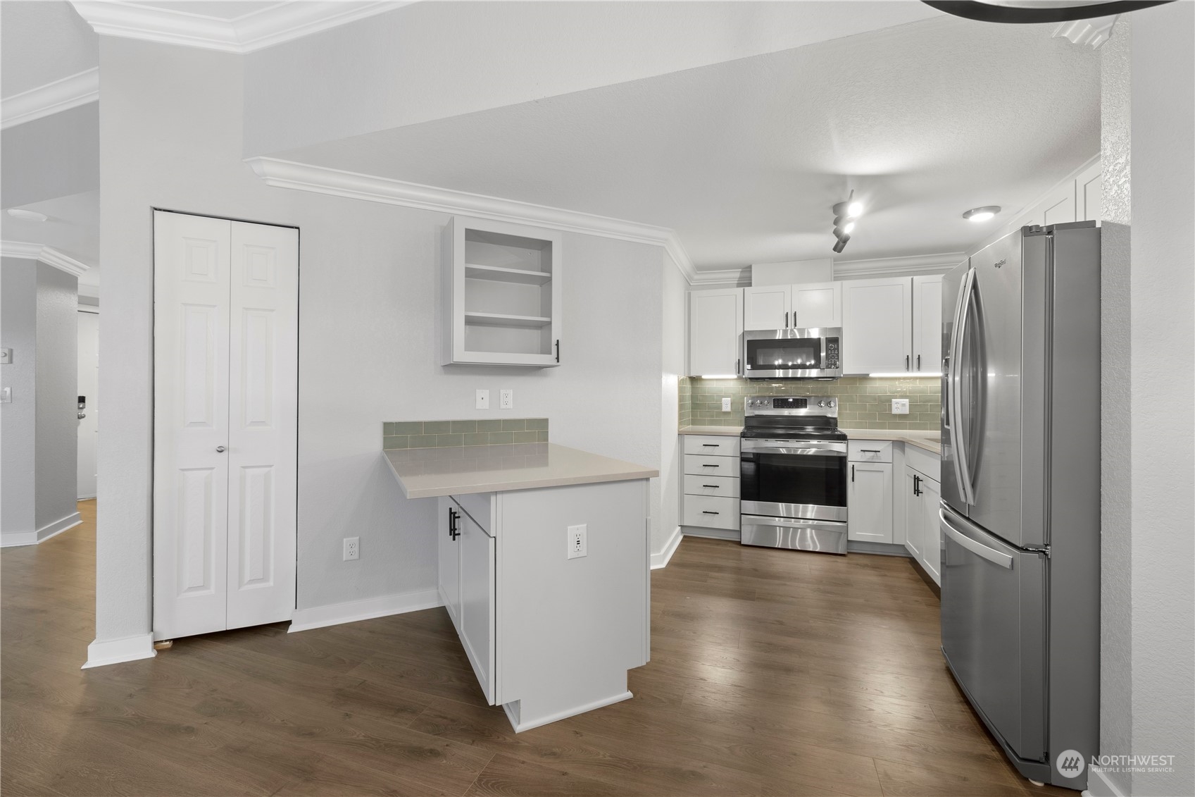 a kitchen with stainless steel appliances a refrigerator and a stove top oven