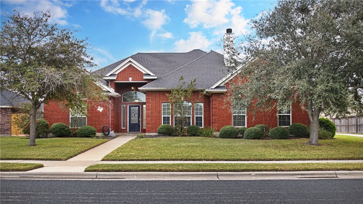 a front view of house with yard and green space