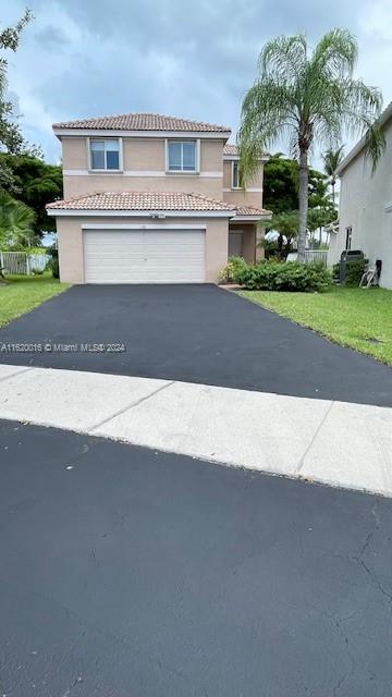 a front view of a house with a yard and garage