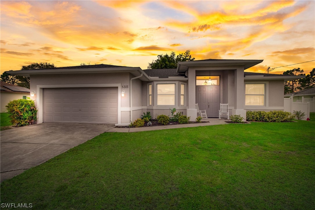 a front view of house with yard and green space