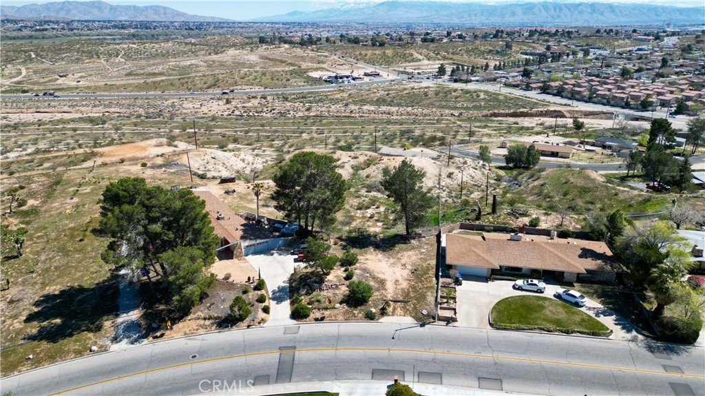 an aerial view of residential houses with outdoor space and river