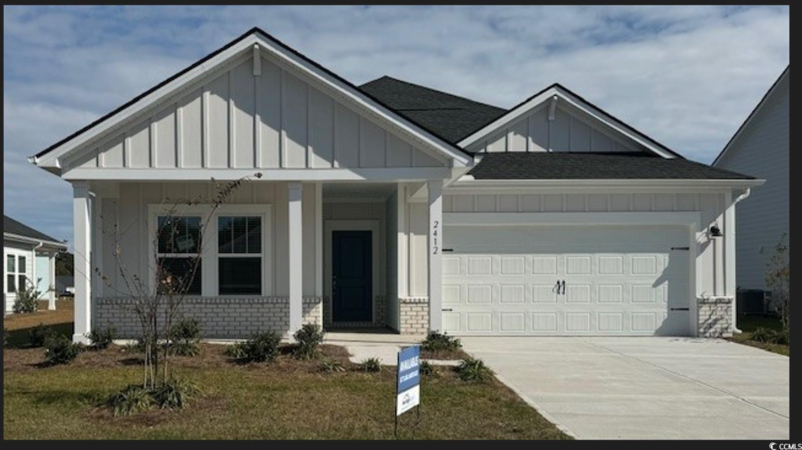 View of front of home featuring central AC, a gara