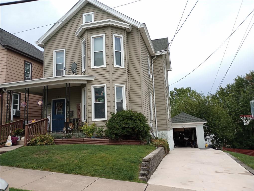 a view of house with yard and front view of a house